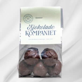 Bilde av Salt Karamell Mørk – pose med ti mørke sjokoladekuler fylt med salt karamell, en fyldig og smakfull godbit.